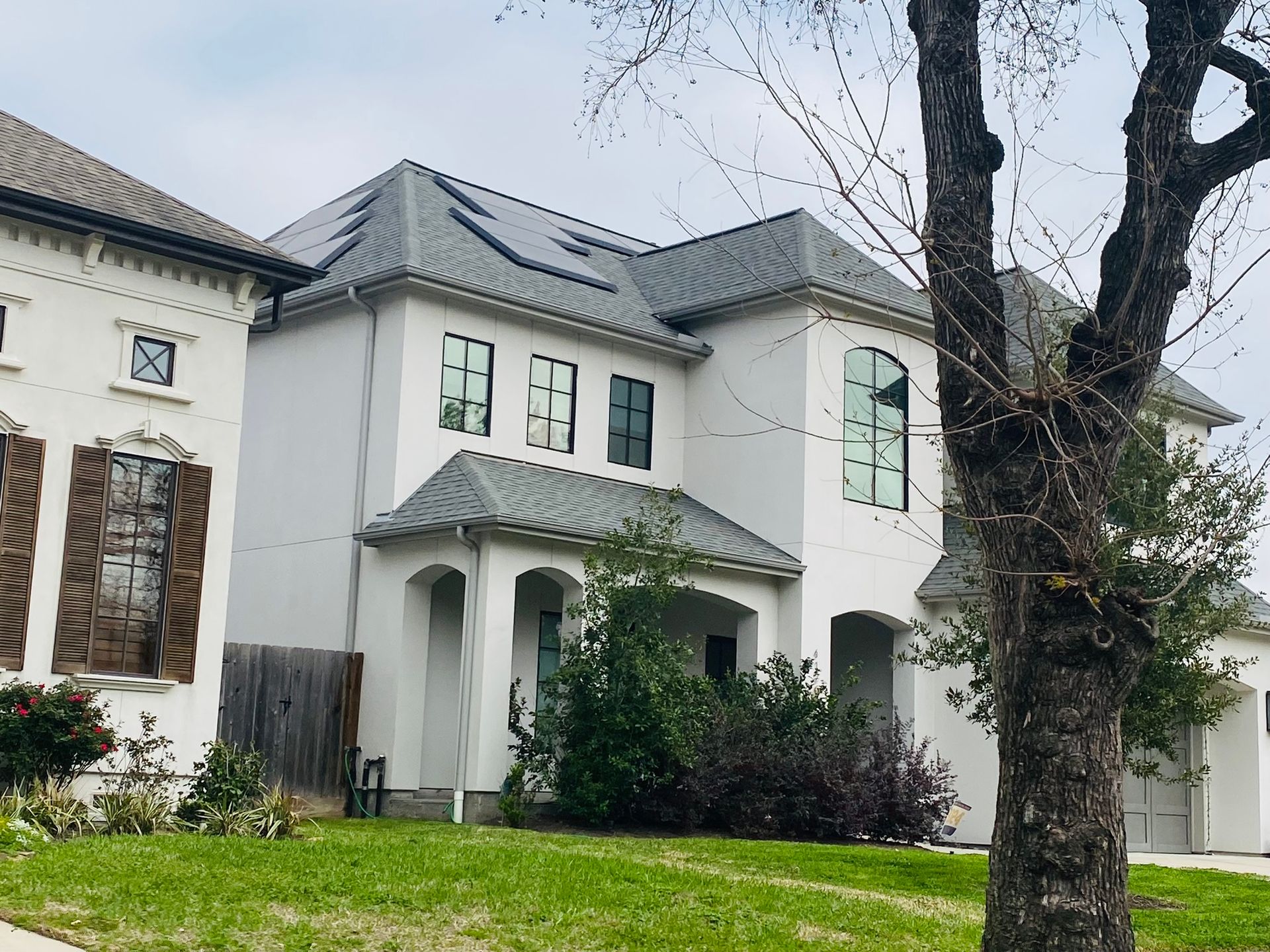 A large white house with a tree in front of it