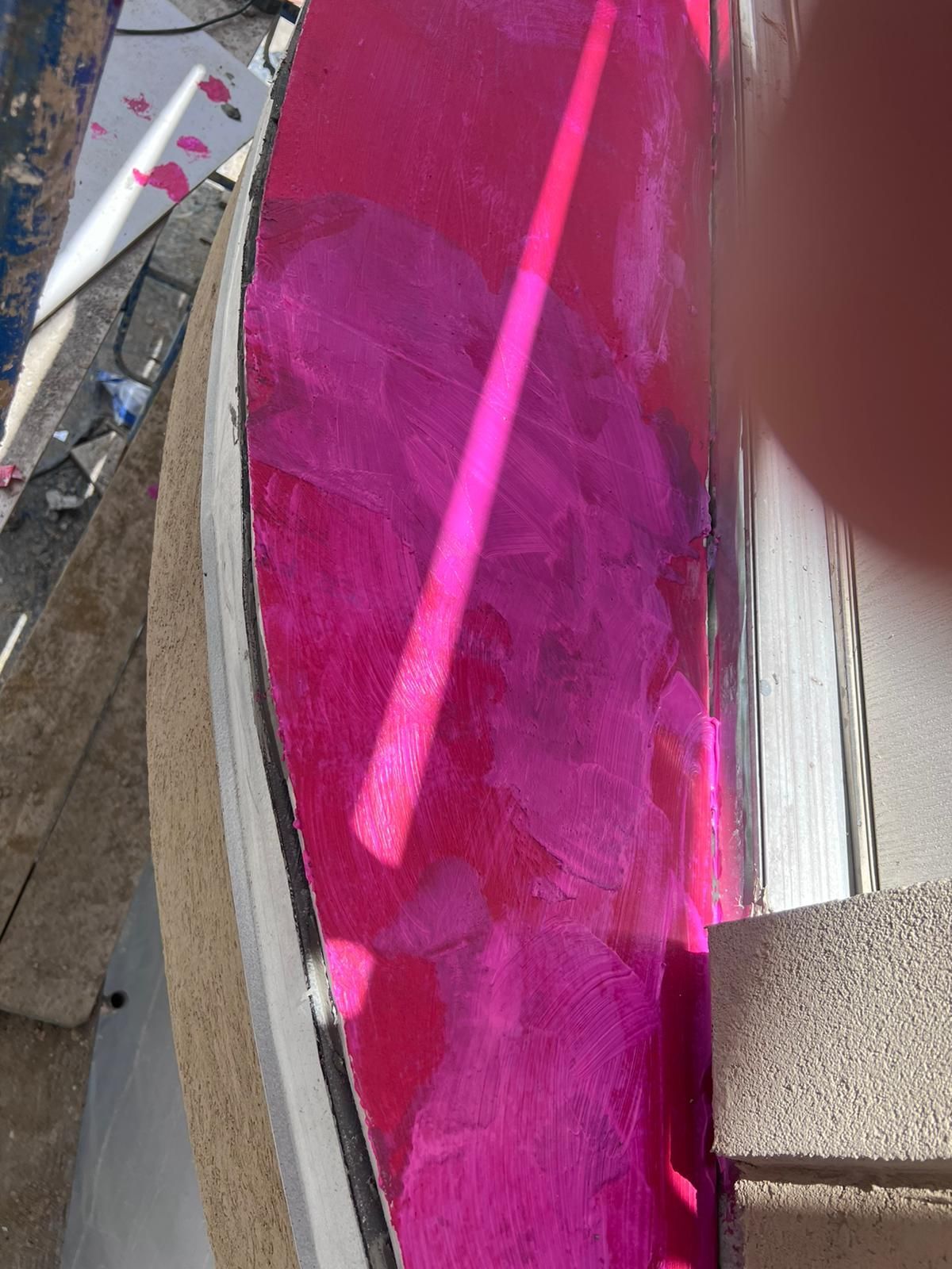 A person is holding a pink object in their hand.