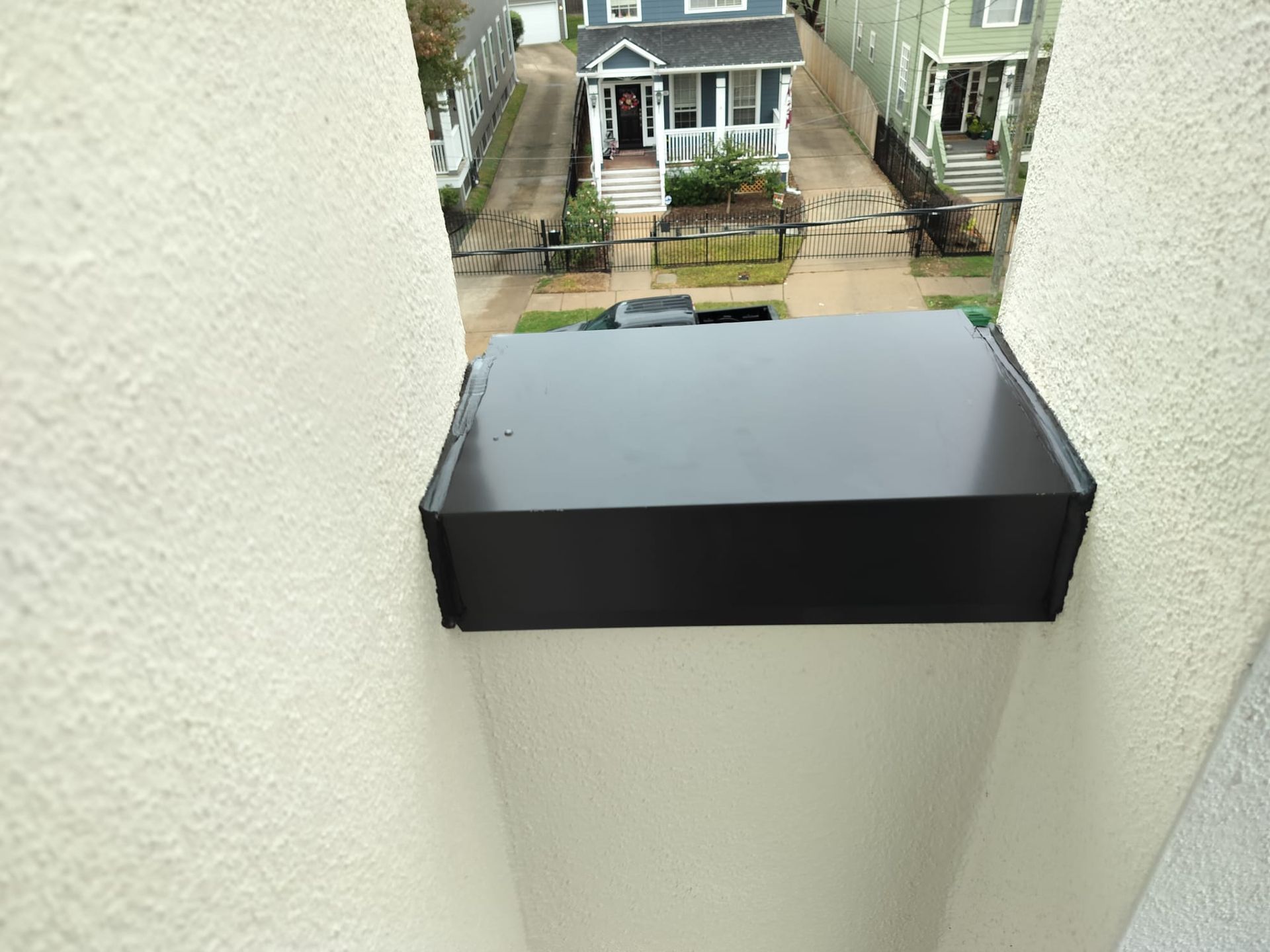 A view of a house from the top of a building