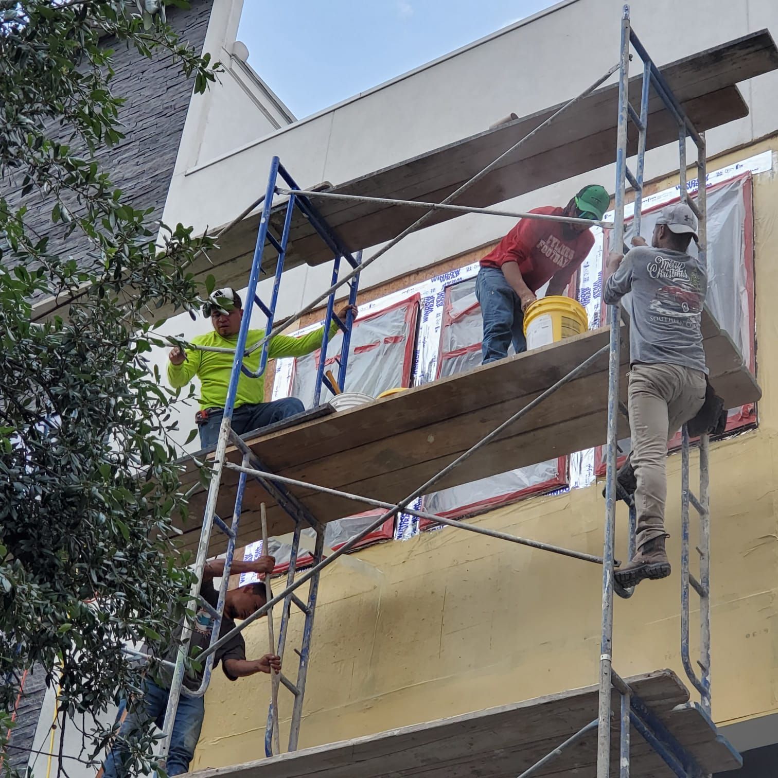 A group of men are working on a building with scaffolding