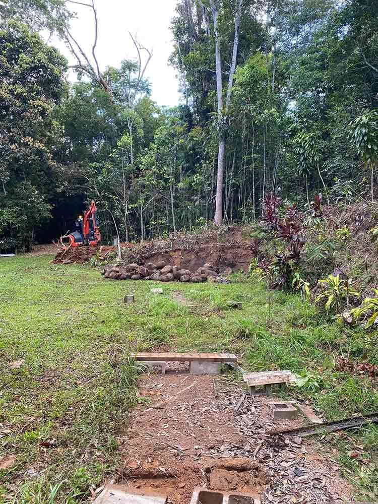 A Dirt Path Going Through a Grassy Field With Trees in the Background — Blue Gum Earthworks in Atherton, QLD
