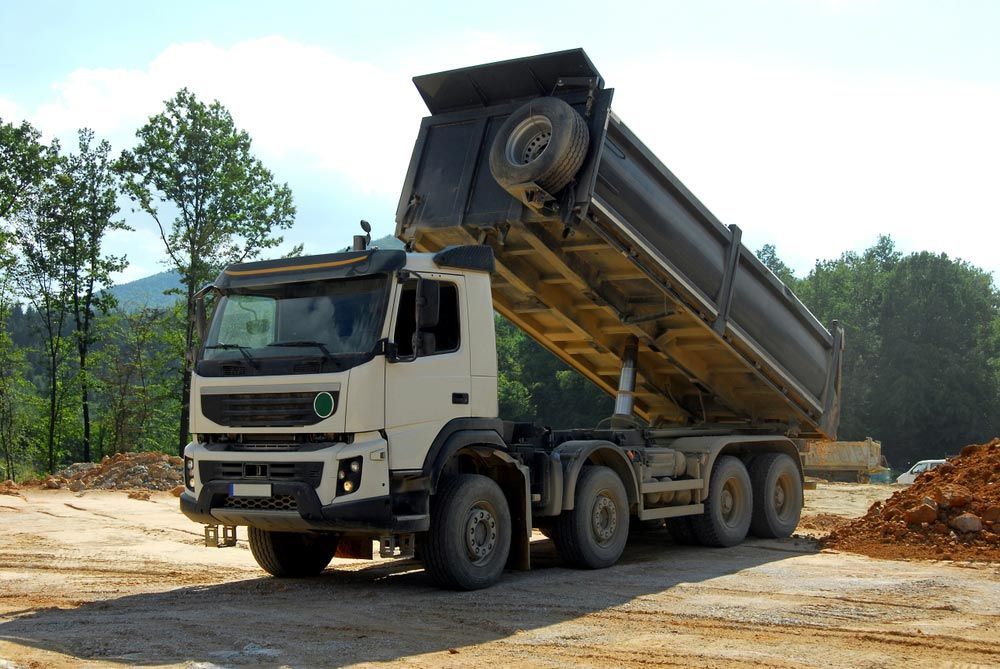 A Dump Truck is Parked in a Dirt Field — Blue Gum Earthworks in Atherton, QLD