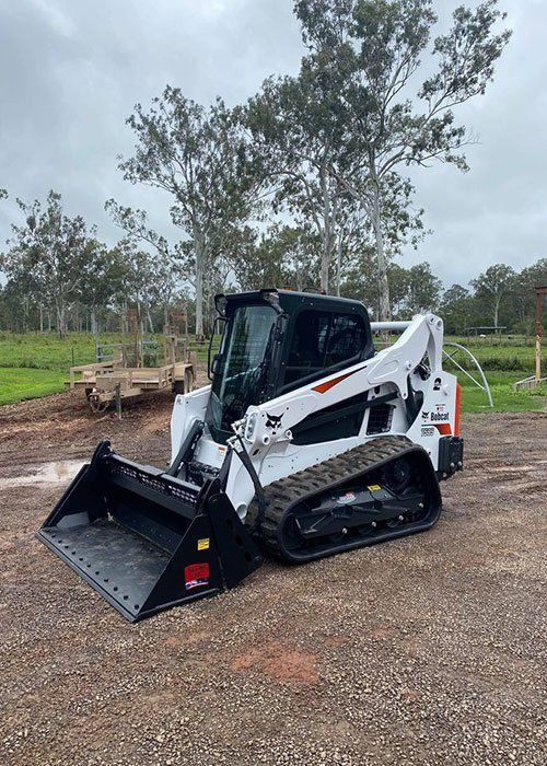 A Bobcat Track Loader is Parked in a Gravel Lot — Blue Gum Earthworks in Atherton, QLD