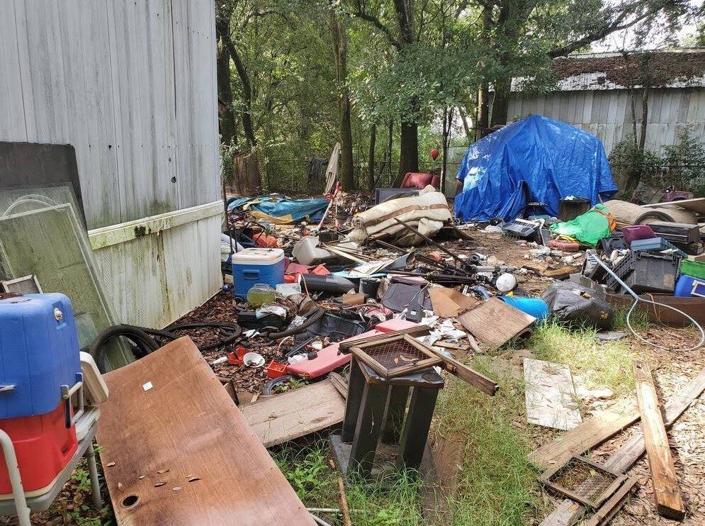There is a lot of trash in the backyard.
