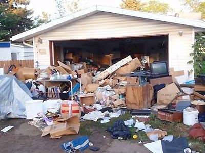A house with a lot of garbage in front of it