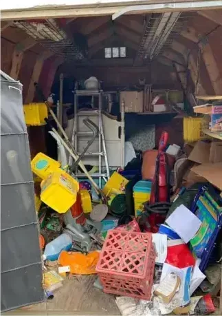 A garage filled with lots of junk and boxes.