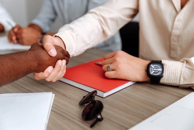 A landlord and property manager shaking hands.