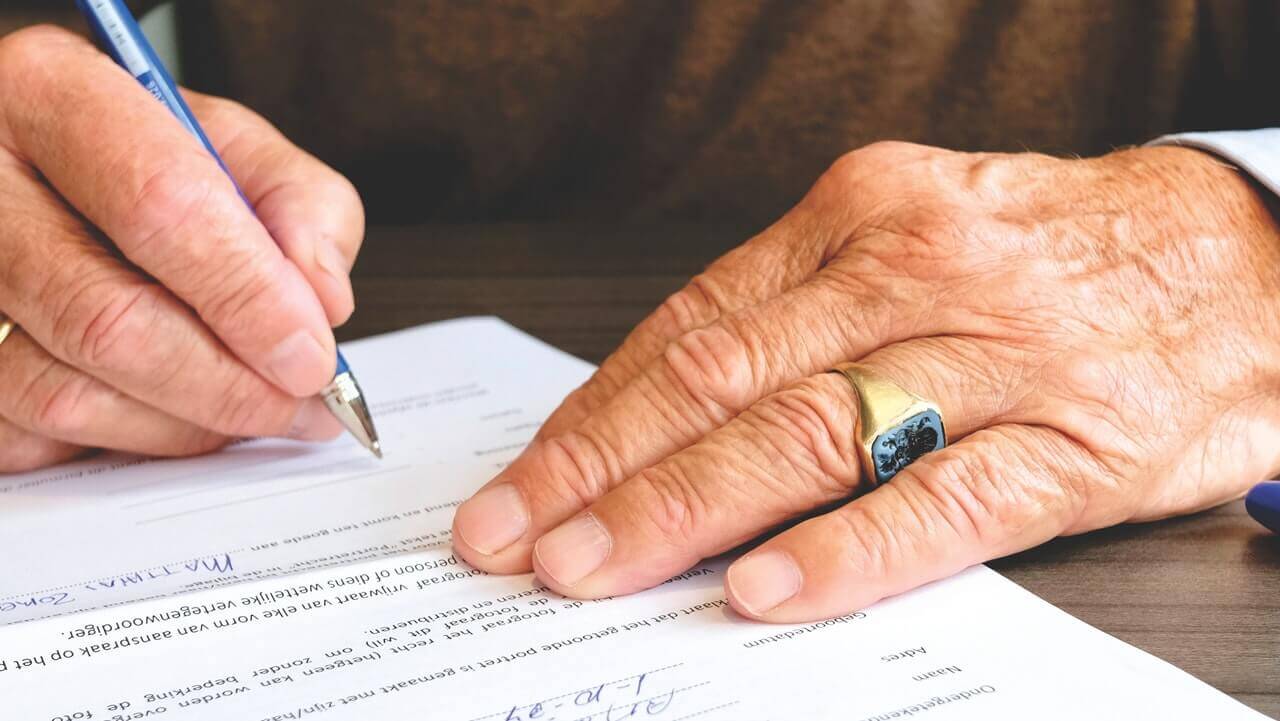 man signing a lease agreement