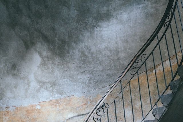 a staircase with a rusty wall