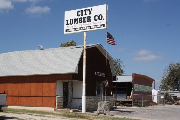 A City Lumber Co. building with a sign in front of it