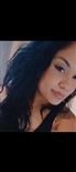 A close up of a woman 's face with long black hair.