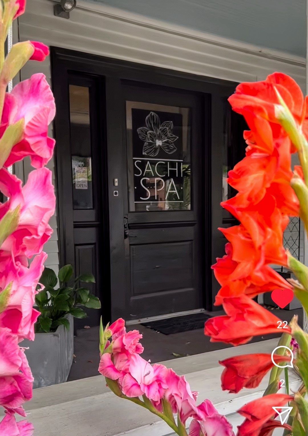 Flowers are in front of a door that says sachs spa