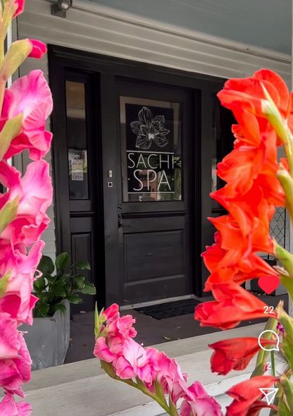 Flowers are in front of a door that says sachs spa