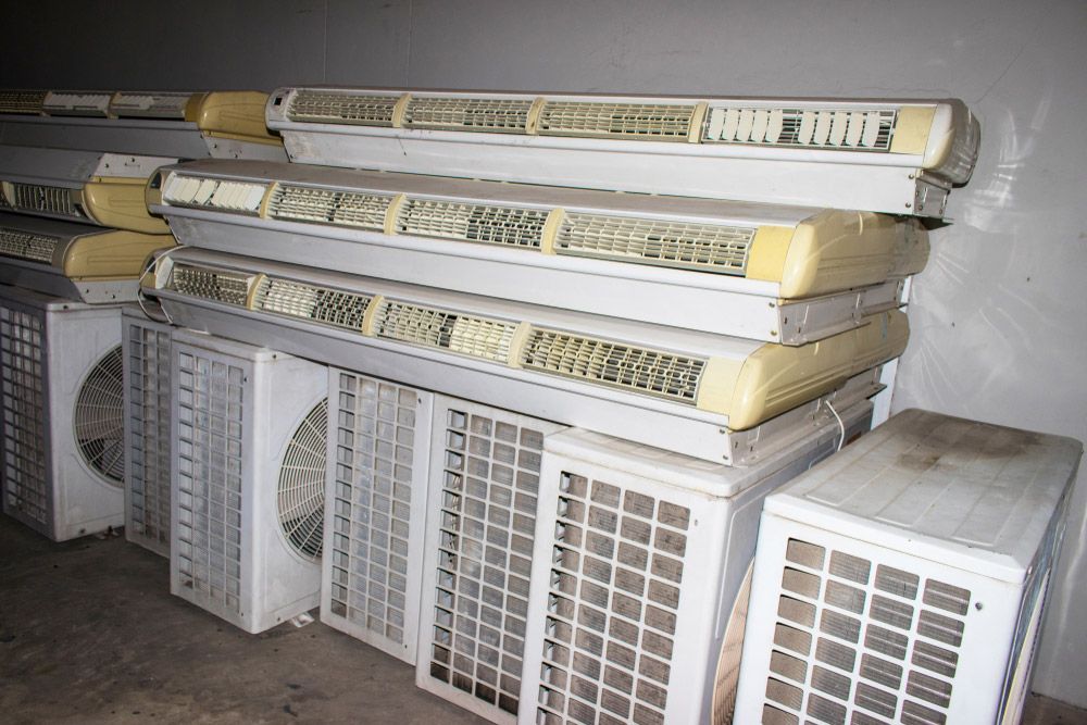 Stack of old and soiled air conditioners, deemed defective and discarded, ready for recycling — Professional Scrap Metal Recycling in Palmerston, NT