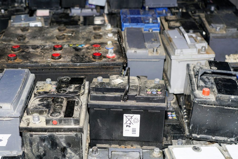 Pallet With Used Car Batteries Waiting To Be Recycled In An Environmentally Harmful Scrap Yard — Professional Scrap Metal Recycling in Woolner, NT