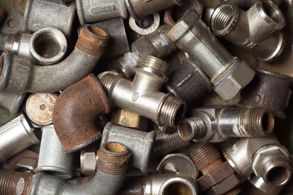 Pile of Used Brass Plumbing Components for Recycling — Professional Scrap Metal Recycling in Darwin, NT