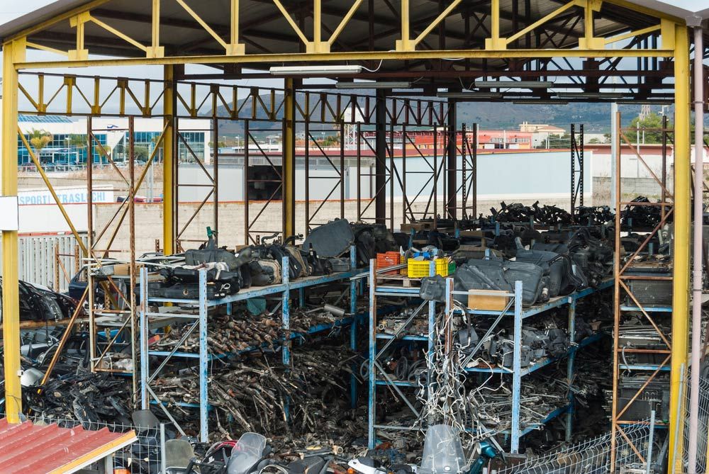 Various recyclable materials neatly stored on racks, ready for recycling — Professional Scrap Metal Recycling in Woolner, NT
