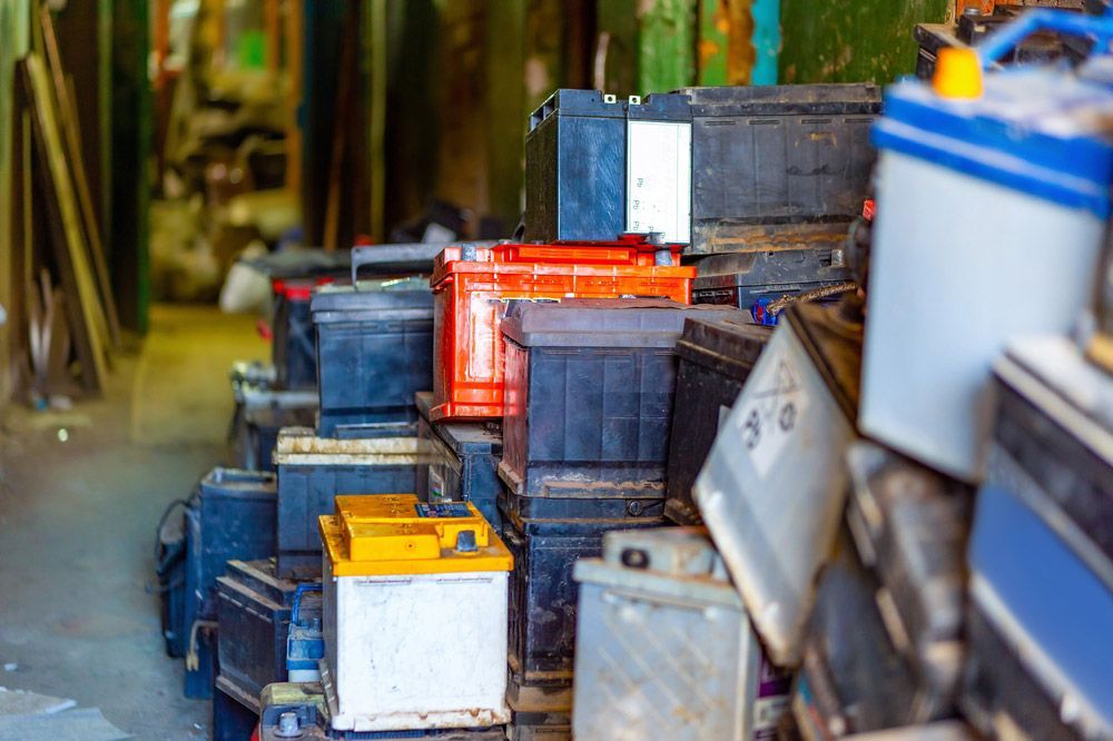 Recycling old car batteries in a garage — Professional Scrap Metal Recycling in Darwin, NT