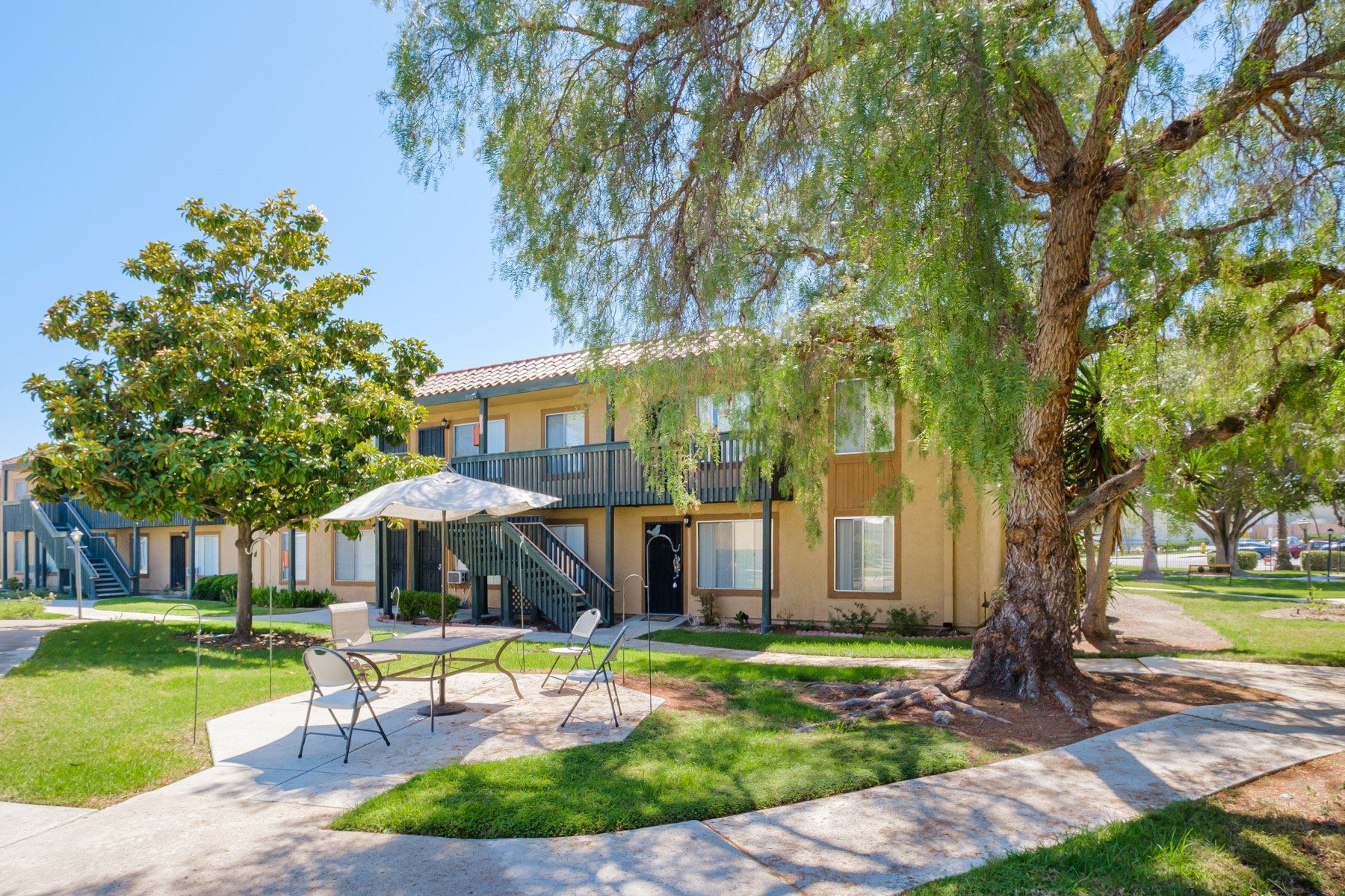 Building exterior with table and chairs in lawn area