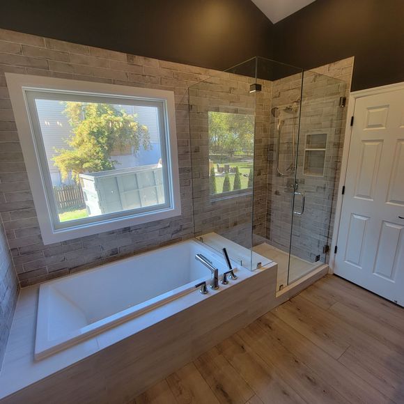 Drop In Tub, Ceramic Tiling on Walls, Marble Floors In Shower, LVP Flooring Around