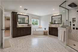 Spacious modern bathroom with double vanities, large mirrors, walk-in shower, and light tile flooring.