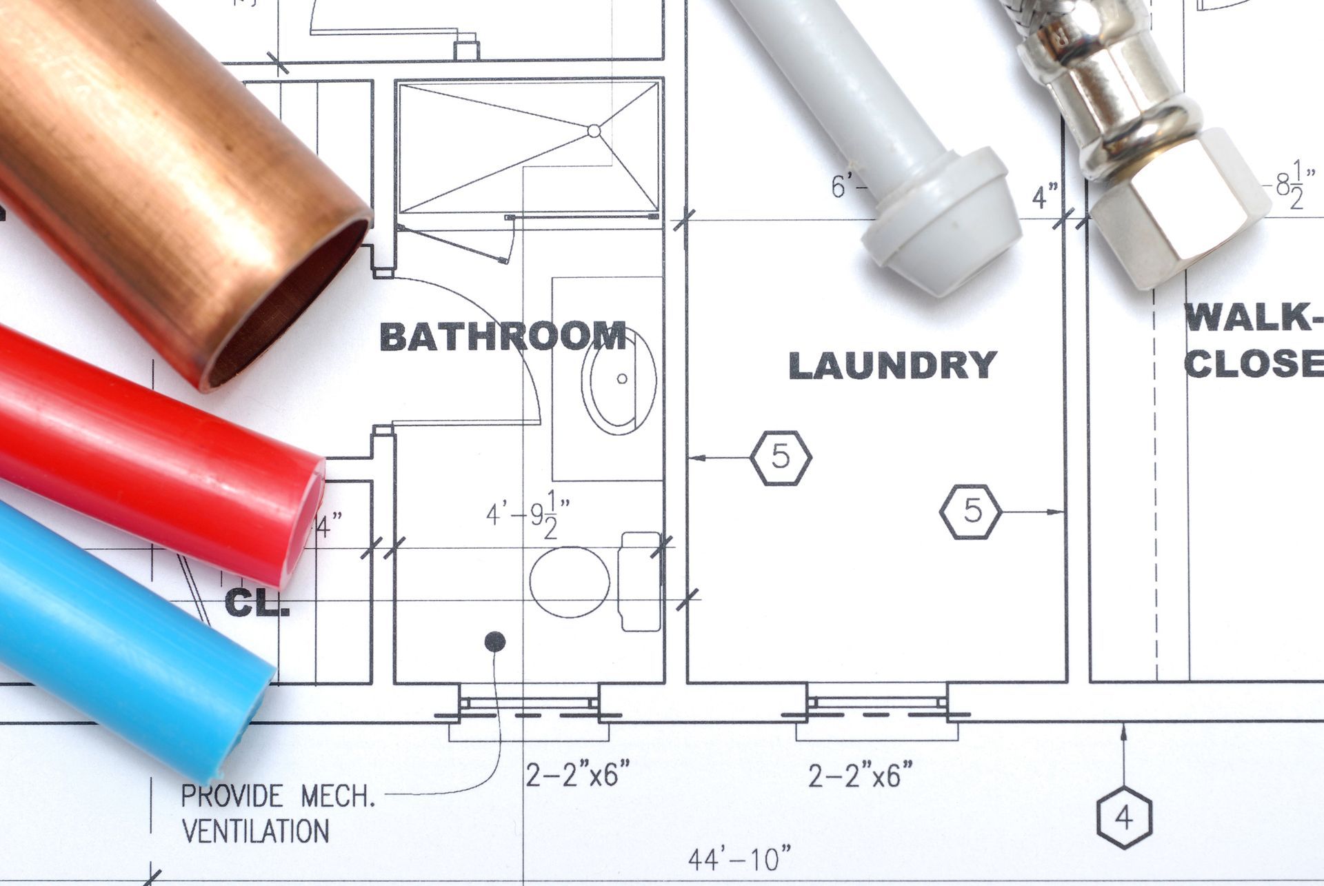 A blueprint of a bathroom and laundry with copper pipes.