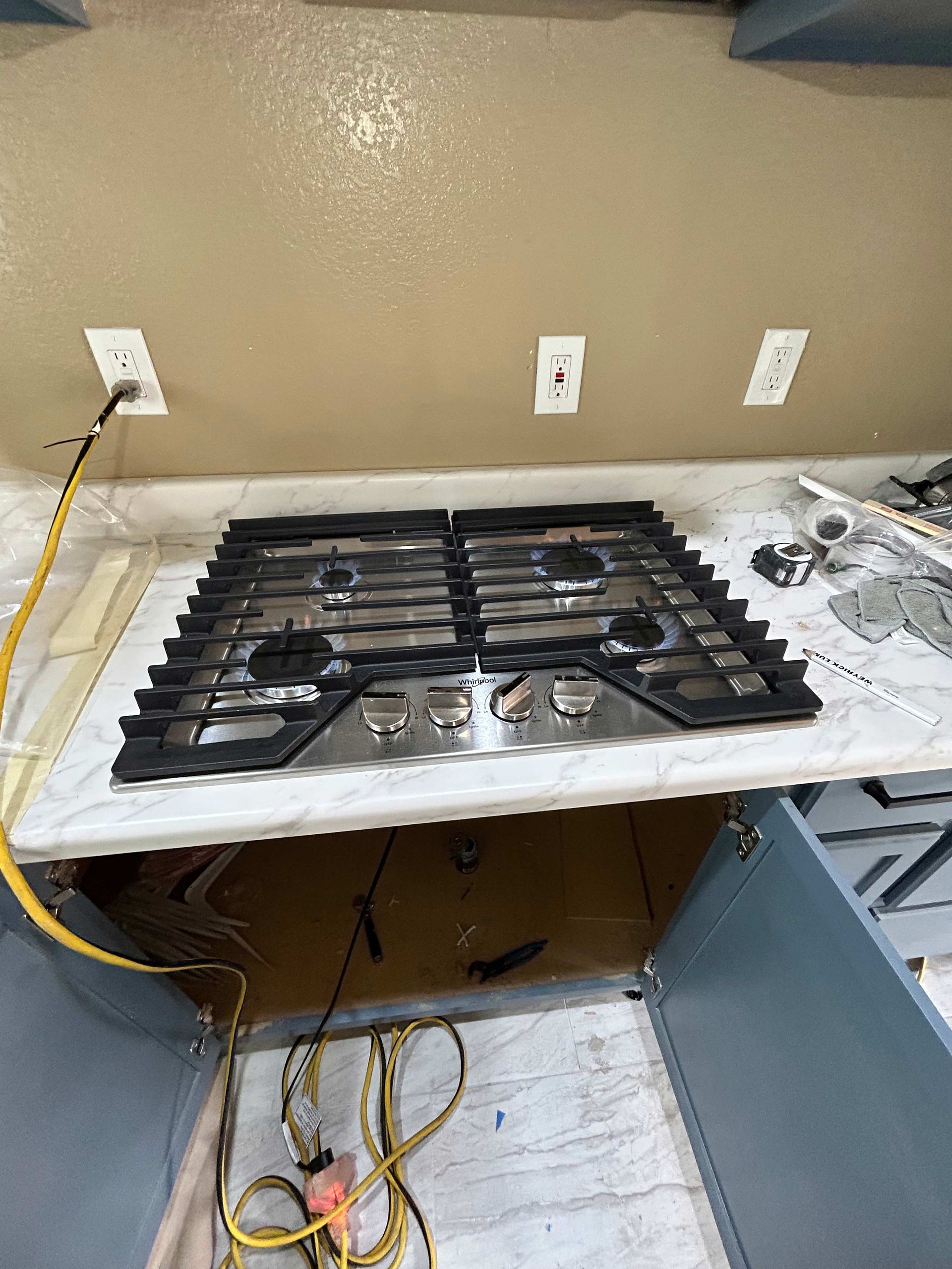 A stove top oven is sitting on top of a counter in a kitchen.