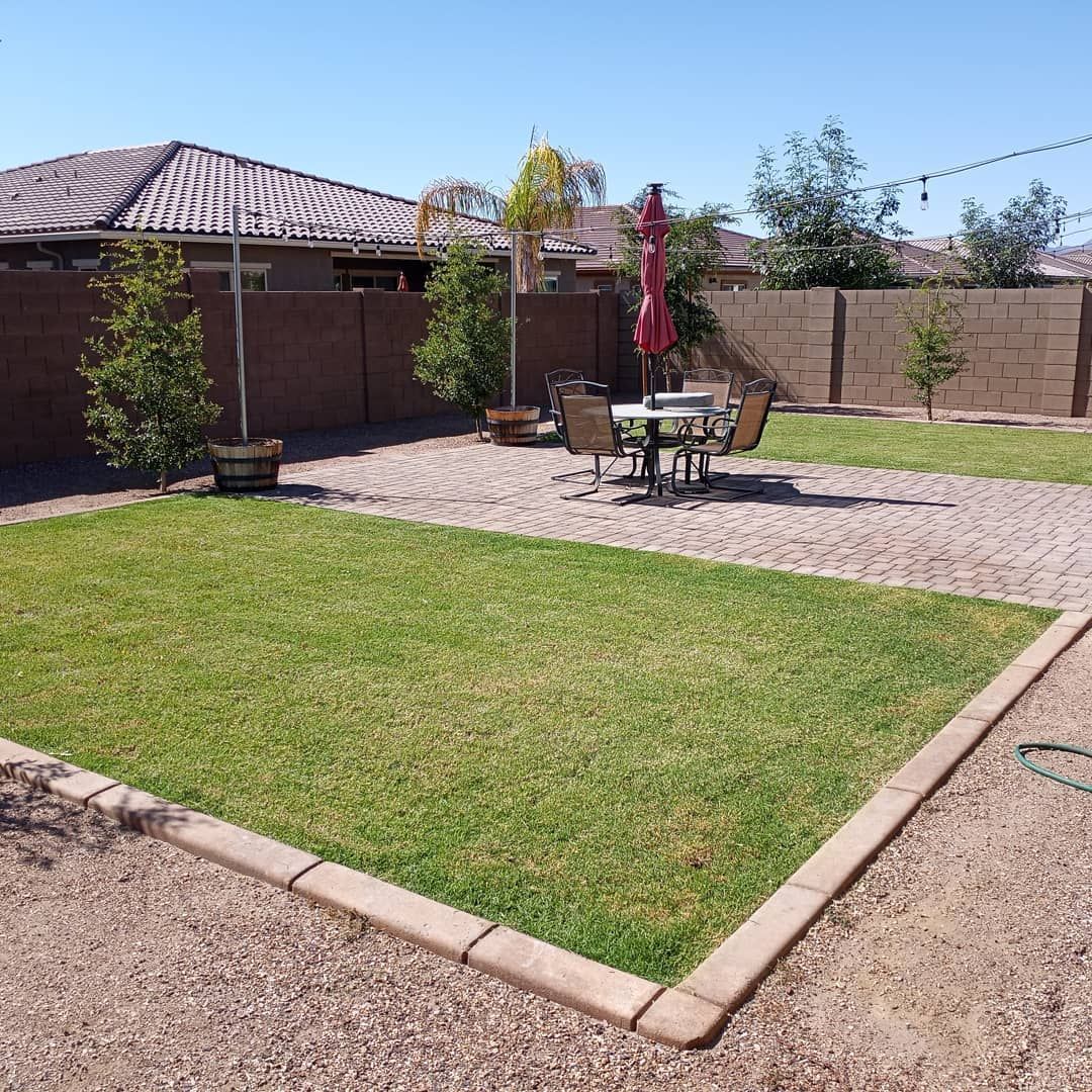 A backyard with a table and chairs in it