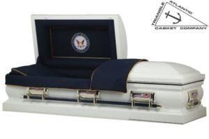 White casket with blue interior, open lid, and a US Navy emblem.