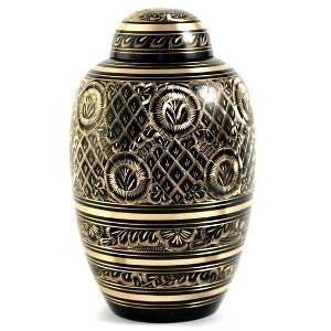 Black and gold cremation urn with ornate floral and geometric patterns.