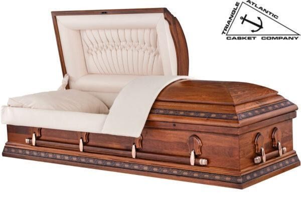 Open wooden casket with cream interior, decorative trim, and an open lid.