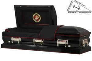 Black casket with open lid, Marine Corps emblem, red trim, silver hardware.
