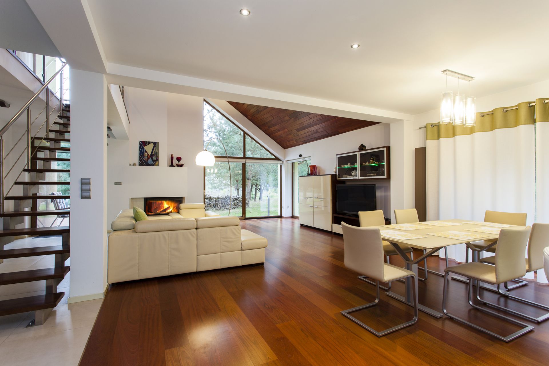 Refinished and restained wide mahogany plank flooring in a living/dining area