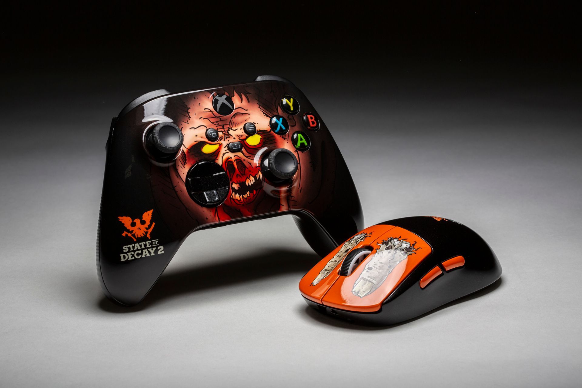 Xbox controller and computer mouse with a juggernaut and zombie fingers on them