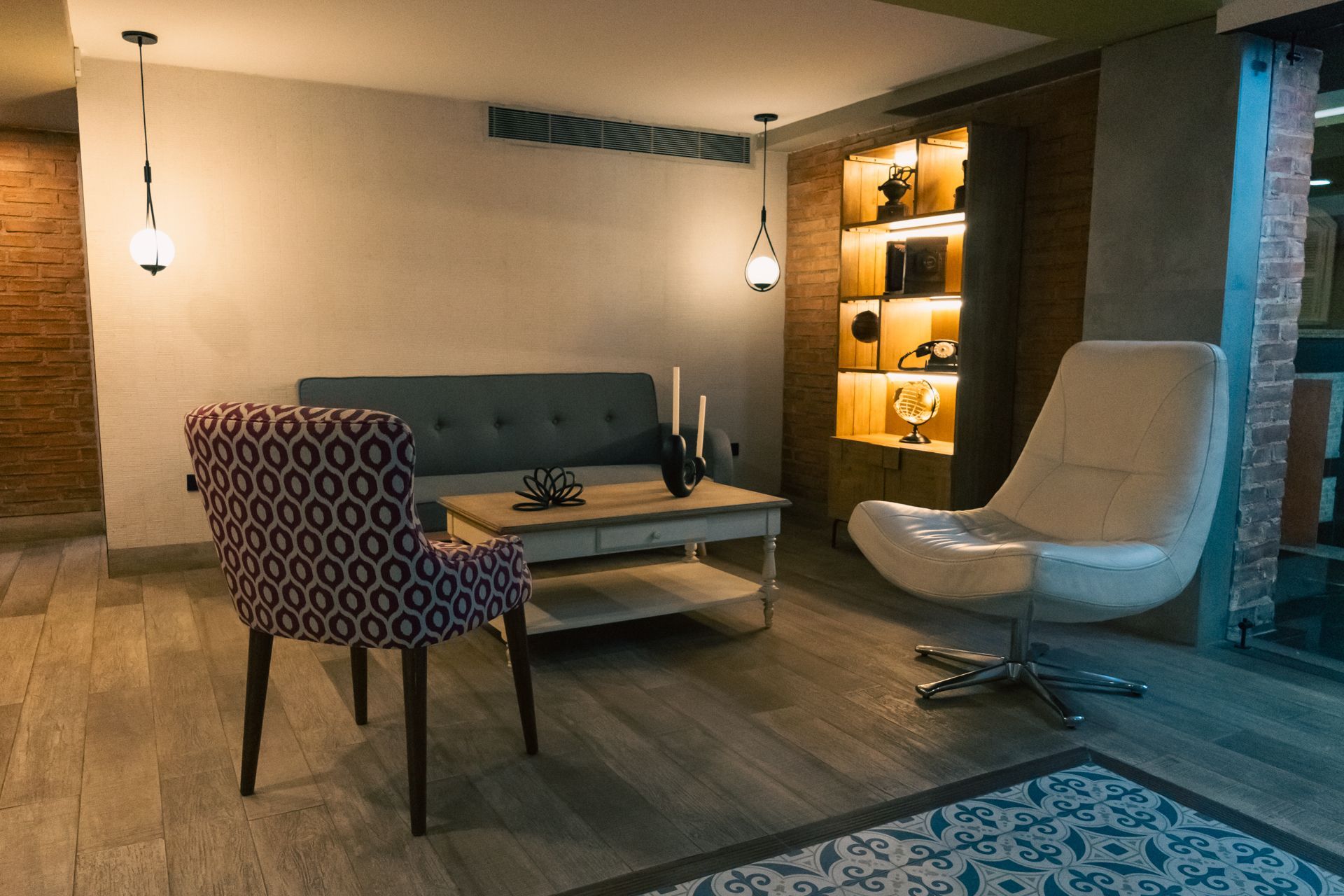 A living room with a couch , chairs , and a coffee table.