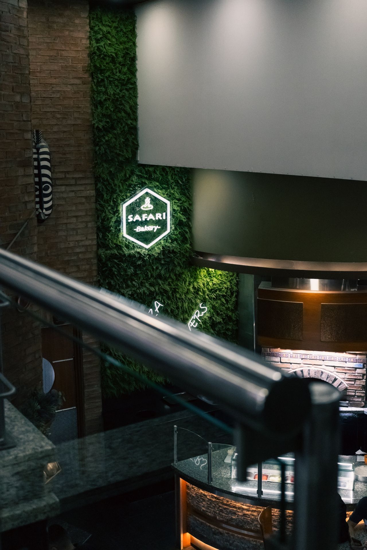 A restaurant with a green wall and a sign on the wall.