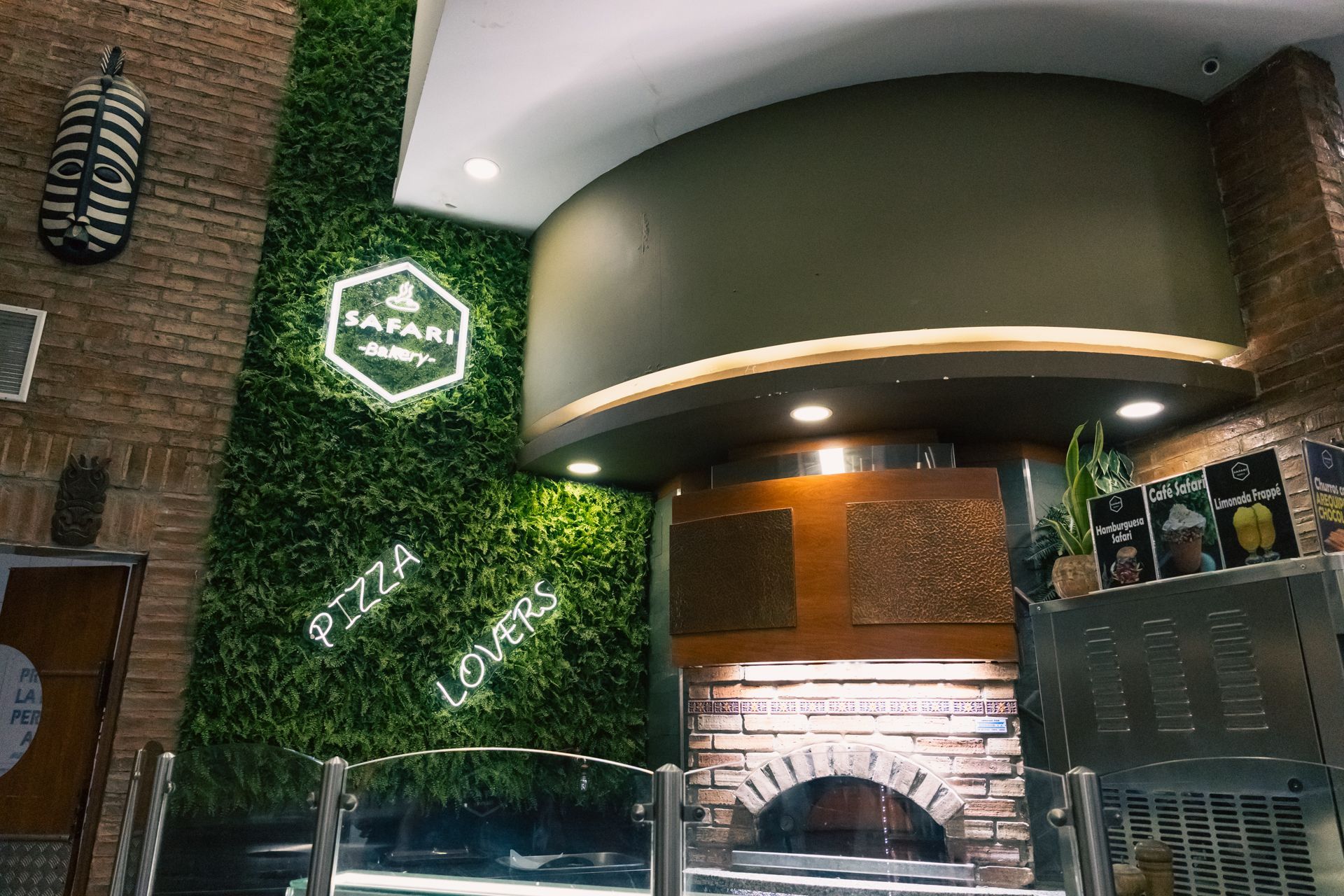 A restaurant with a pizza oven and a sign that says pizza lovers
