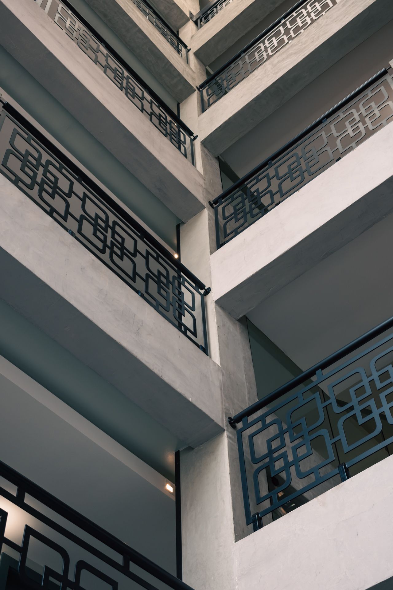 Looking up at a building with balconies and railings