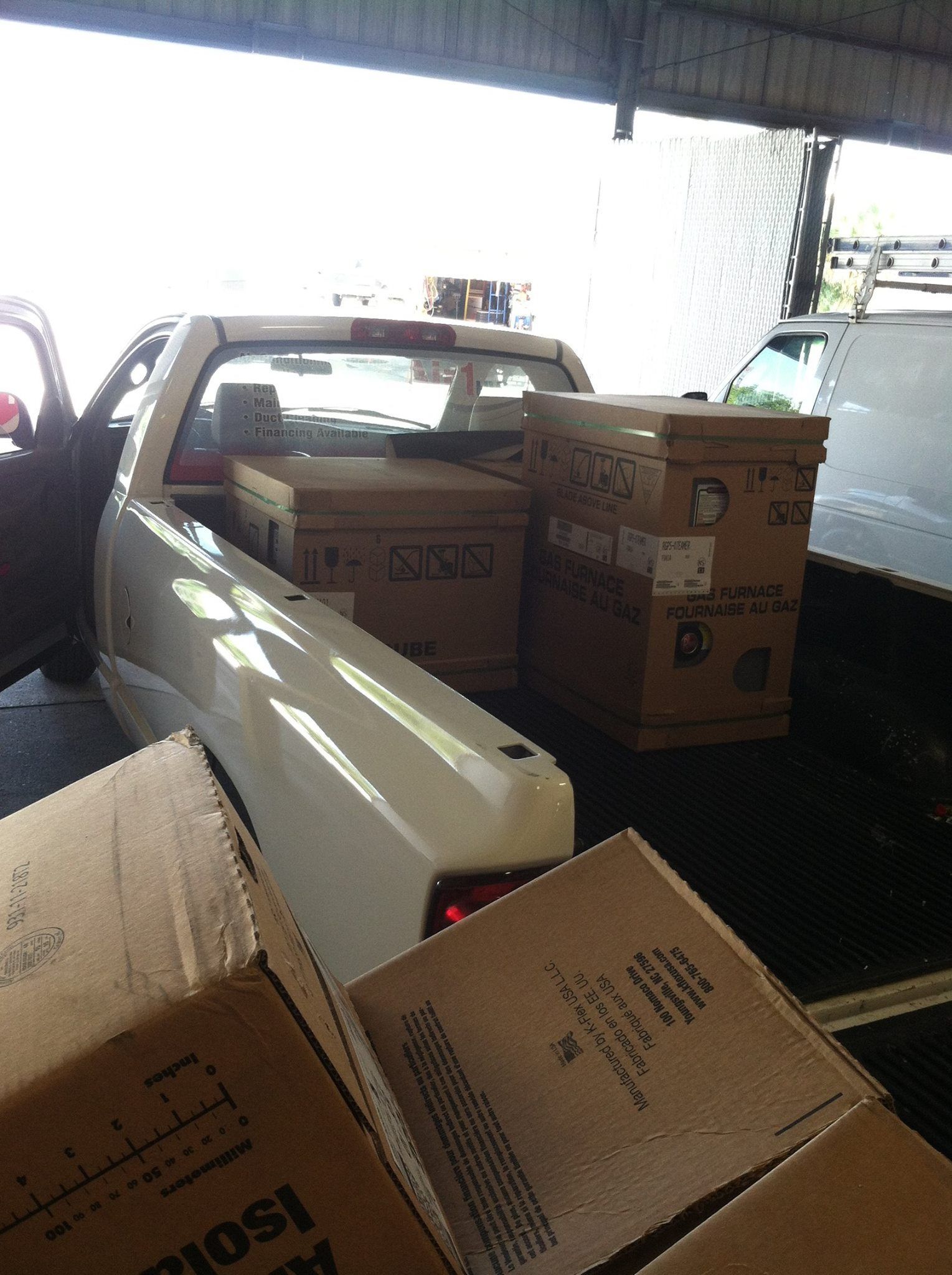 a man wearing a shirt that says ' texas ' on it is carrying a box