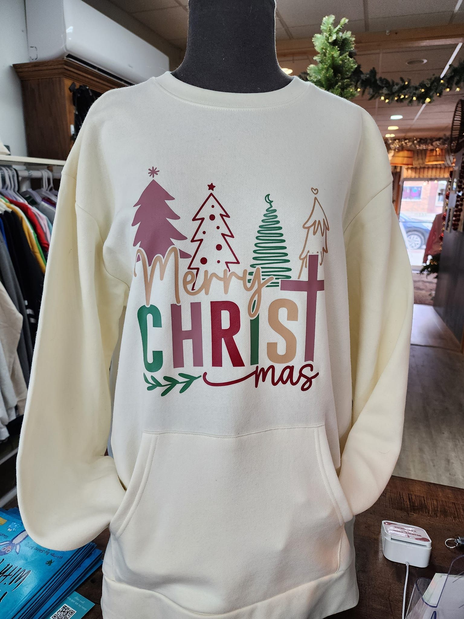 Cream-colored Christmas sweatshirt with colorful trees and