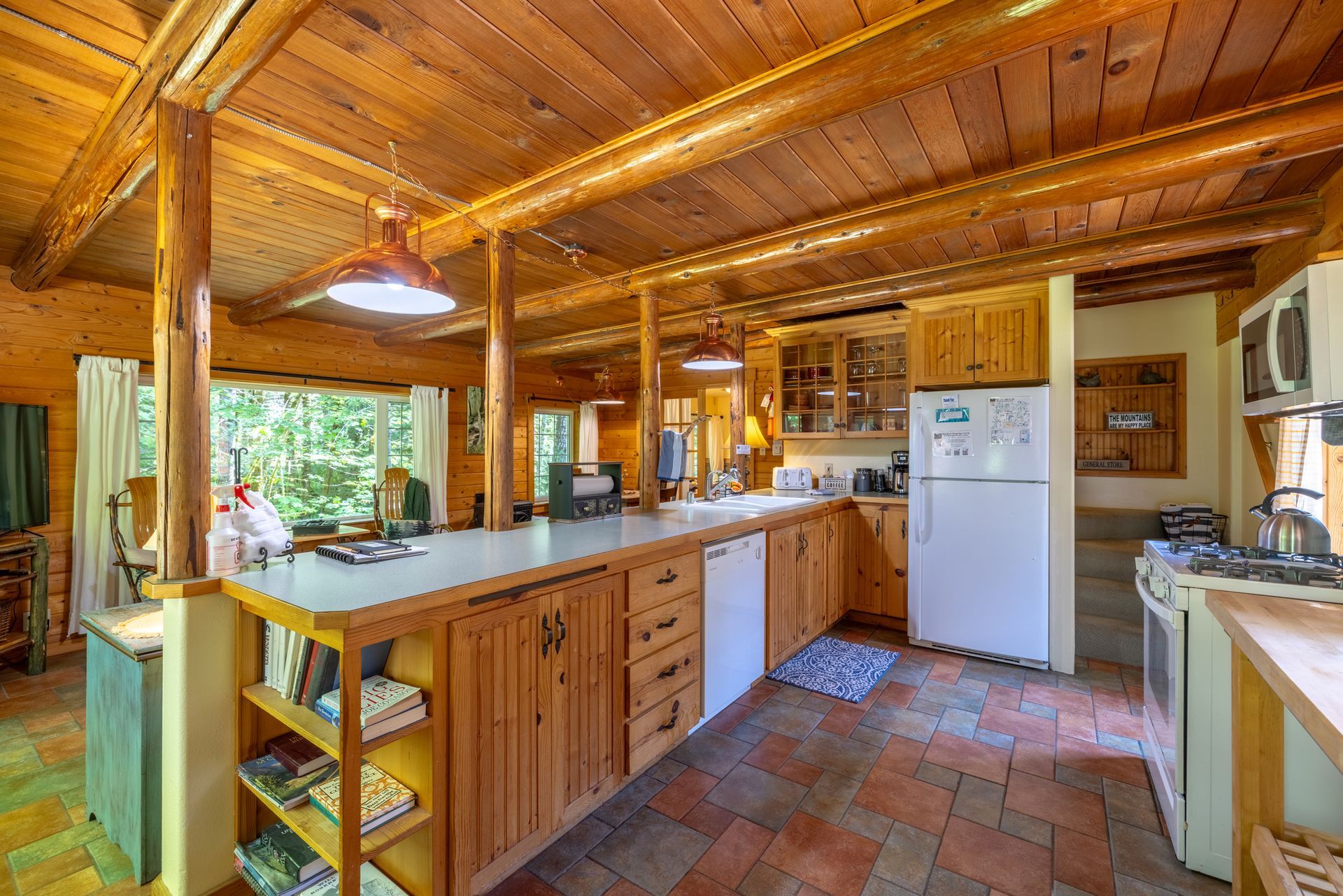A kitchen with wooden cabinets and a white refrigerator.