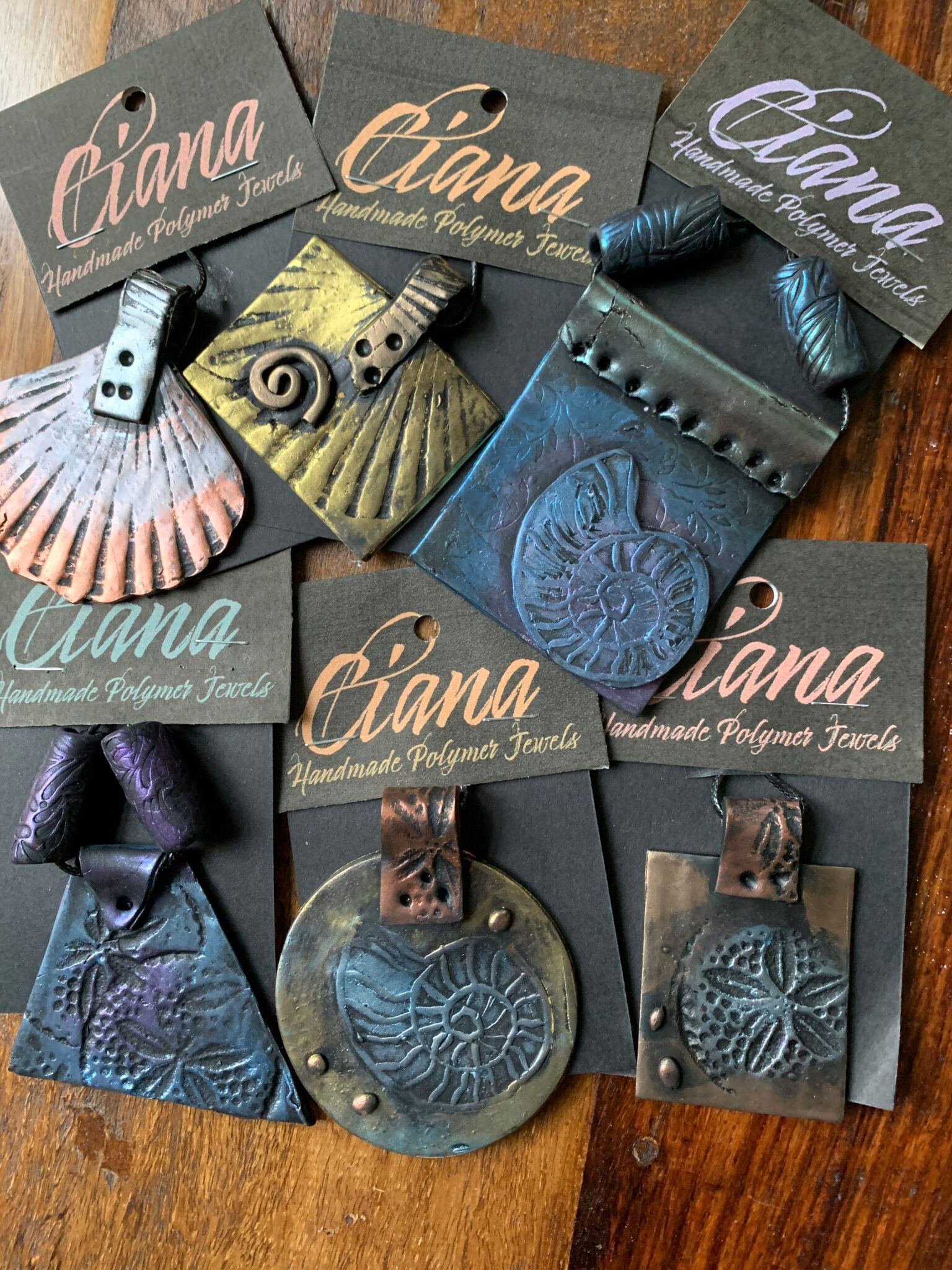 A bunch of jewelry sitting on top of each other on a wooden table.