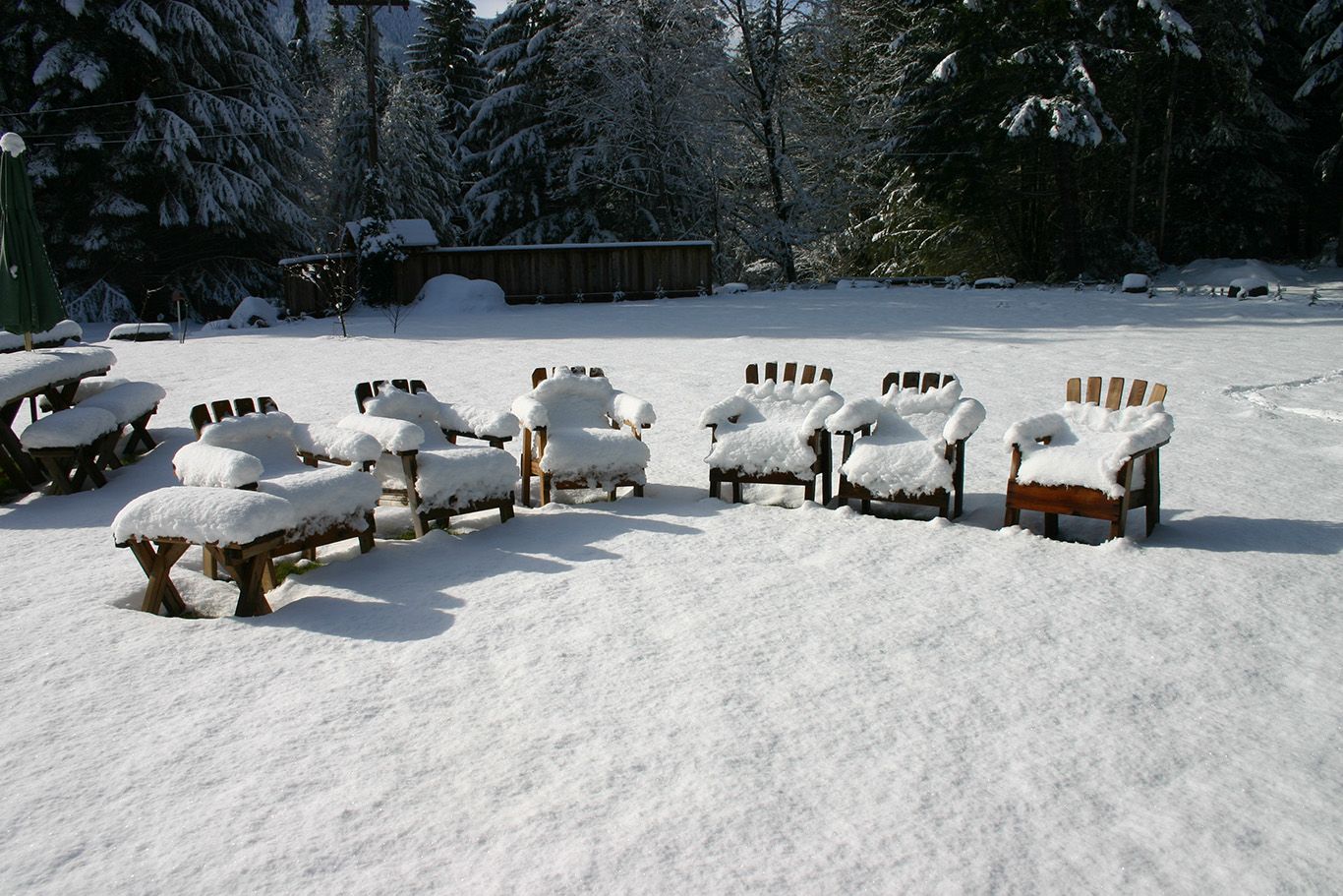A row of chairs and benches covered in snow
