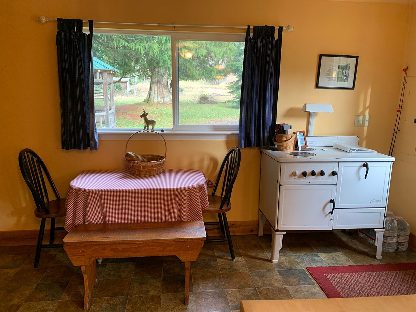 A kitchen with a table and chairs and a stove.