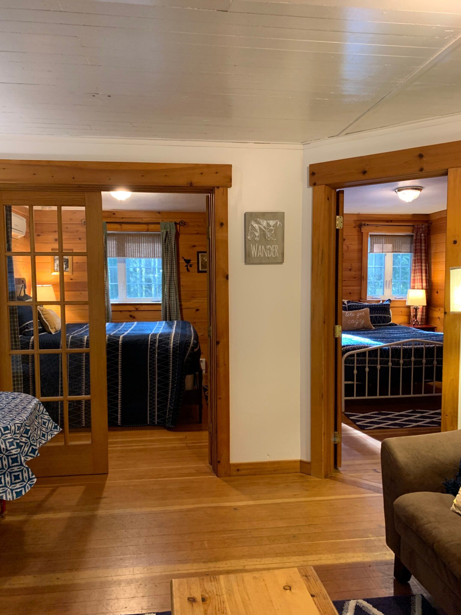 A living room with sliding glass doors leading to a bedroom