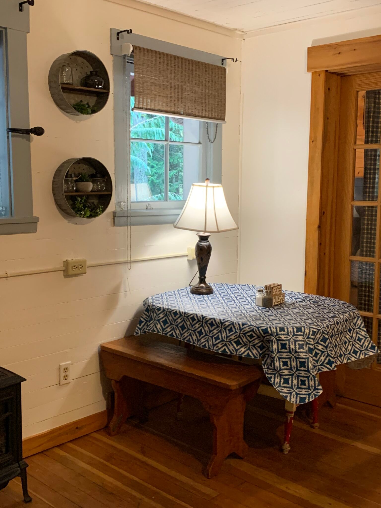 A room with a table and a lamp in it