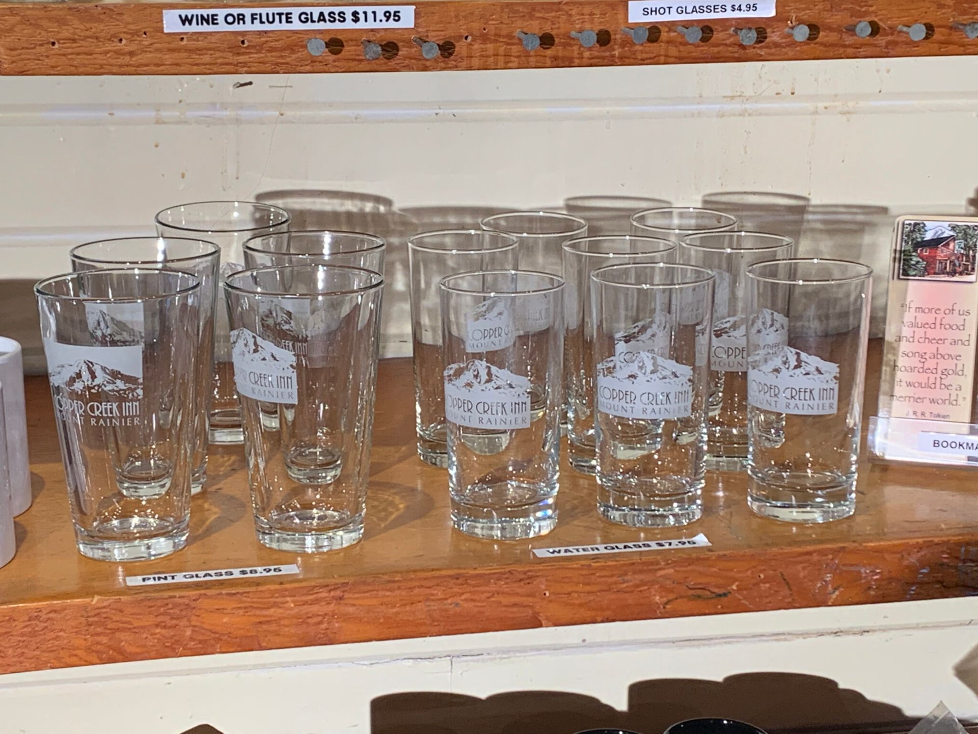 A shelf full of clear glasses with mountains on them