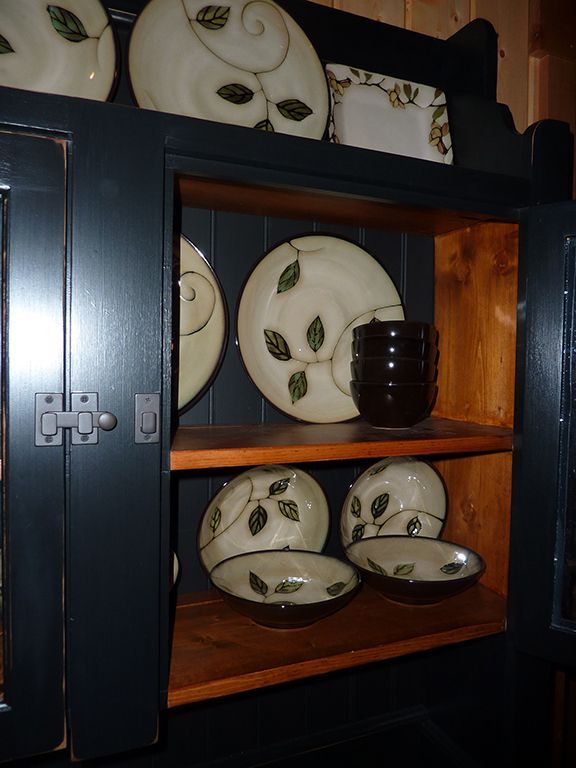 A shelf with plates and bowls on it