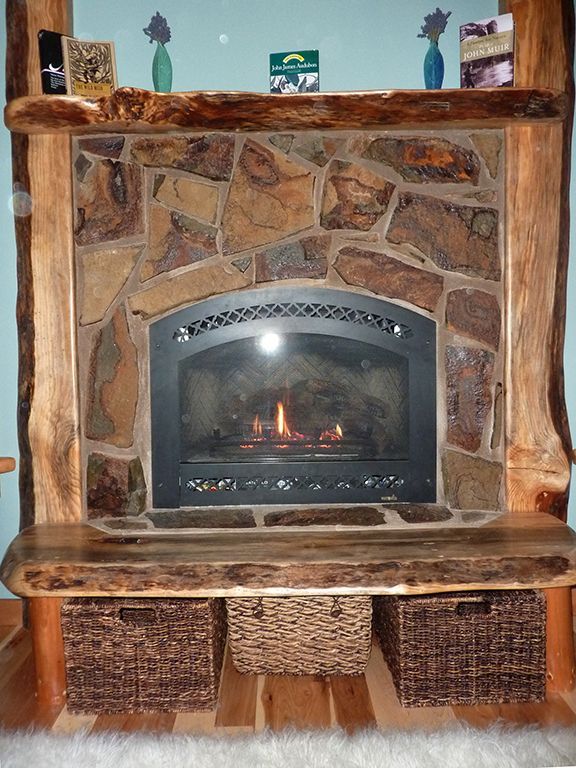 A fireplace with wicker baskets underneath it