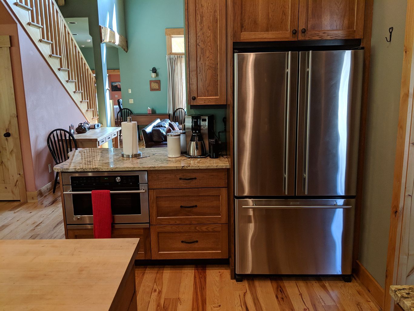 A kitchen with stainless steel appliances and wooden cabinets